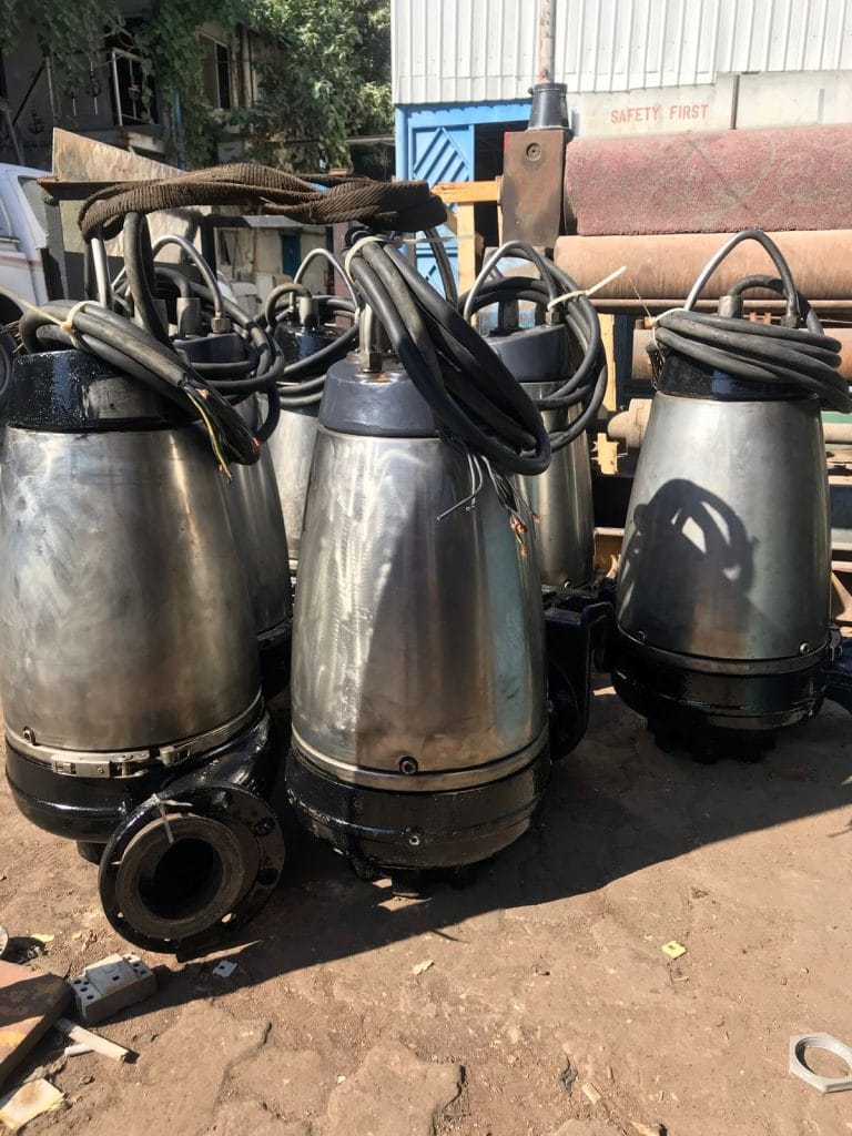 Submersible pumps awaiting overhaul in the workshop yard