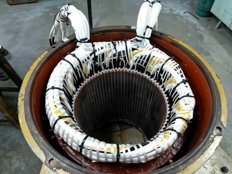 Electric motor stator during coil rewinding in the AME workshop