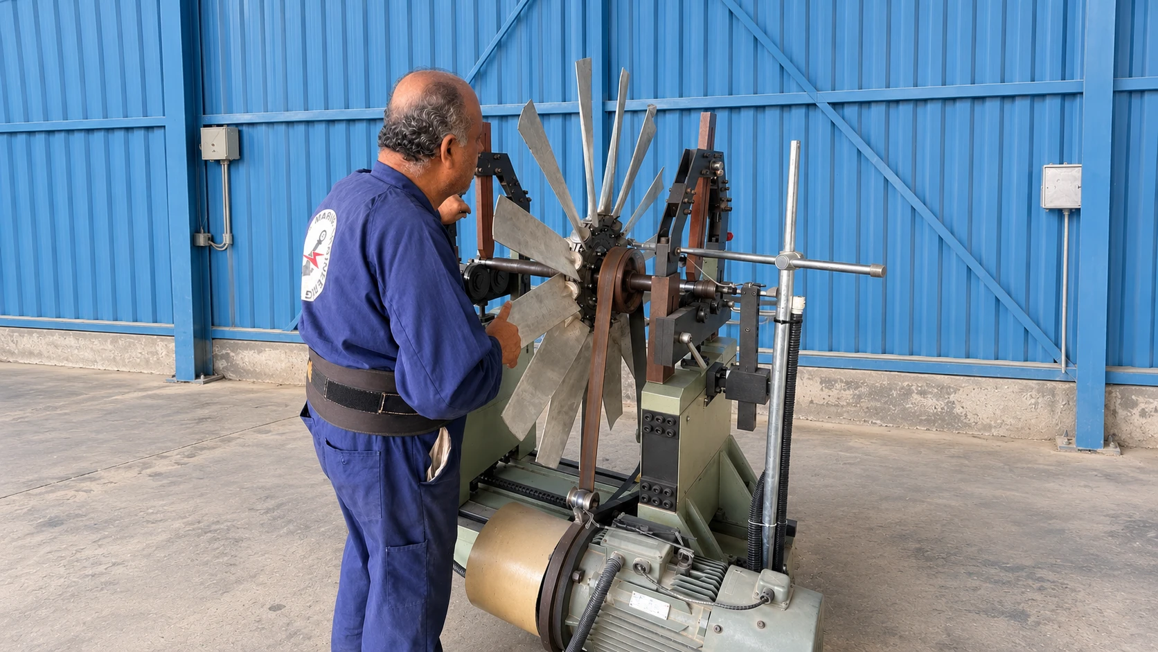 Technician balancing a fan on the dynamic balancing machine in the AME workshop, Dubai