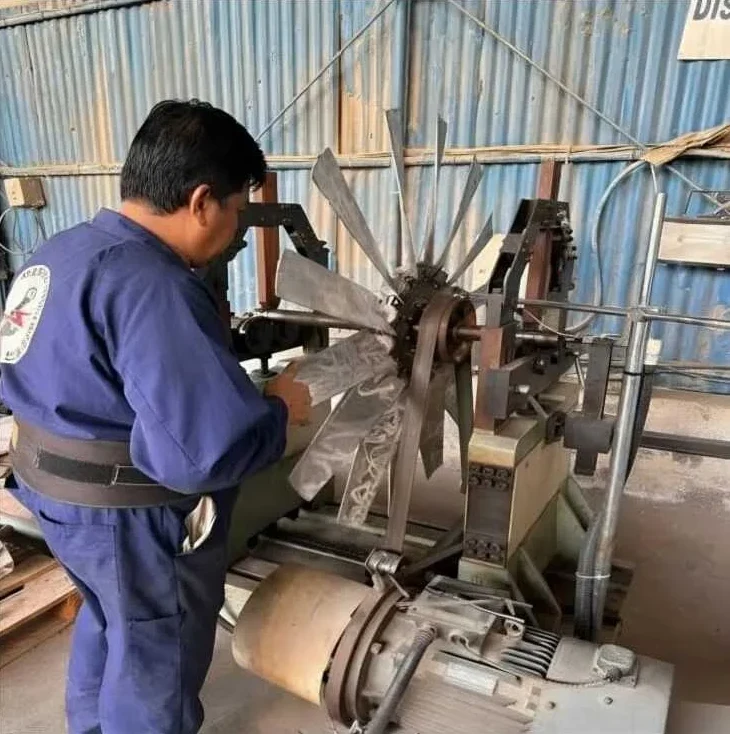 Technician balancing a fan rotor on the dynamic balancing machine