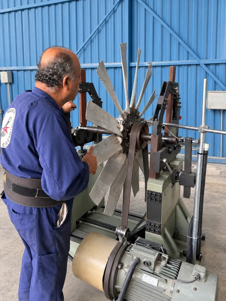 Technician balancing an axial fan impeller on the dynamic balancing machine