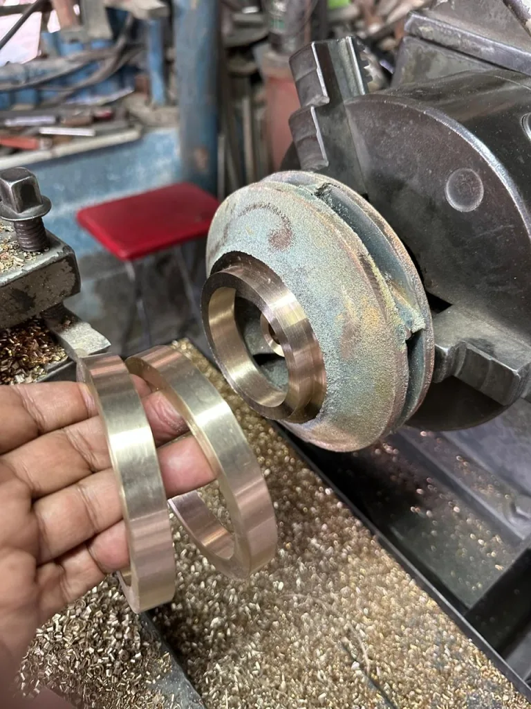 New bronze wear rings machined to fit a pump impeller on the lathe