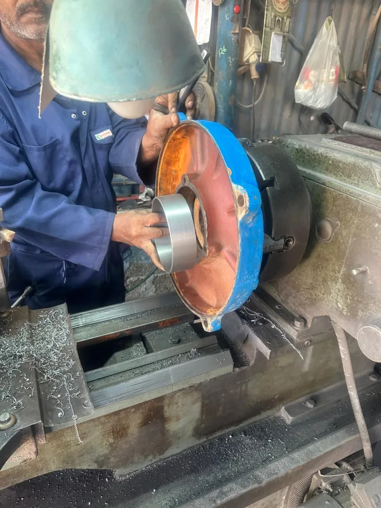 Machined steel sleeve fitted to a motor end cover on the lathe